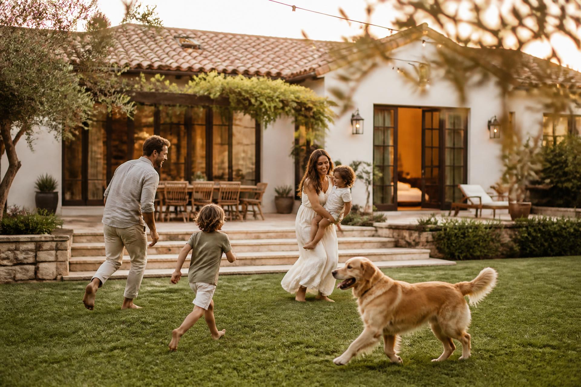 California family enjoying a lush green backyard at golden hour